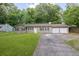 Traditional home featuring a two-car garage, dark shutters and green grass at 103 Sir Gregory Nw Mnr, Lawrenceville, GA 30044