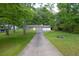 Traditional home featuring a two-car garage, and a long driveway at 103 Sir Gregory Nw Mnr, Lawrenceville, GA 30044