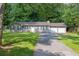 Traditional home featuring a two-car garage, dark shutters and green grass at 103 Sir Gregory Nw Mnr, Lawrenceville, GA 30044
