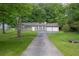Traditional home featuring a two-car garage, and a long driveway at 103 Sir Gregory Nw Mnr, Lawrenceville, GA 30044