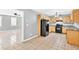 Open concept kitchen with modern appliances and tiled floors at 103 Sir Gregory Nw Mnr, Lawrenceville, GA 30044