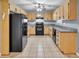 Well-lit kitchen with tiled floors, granite countertops, and black appliances at 103 Sir Gregory Nw Mnr, Lawrenceville, GA 30044