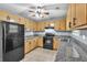 Well-lit kitchen with tiled floors, granite countertops, and black appliances at 103 Sir Gregory Nw Mnr, Lawrenceville, GA 30044