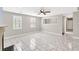Bright living room with tile flooring, ceiling fan and view into another room at 103 Sir Gregory Nw Mnr, Lawrenceville, GA 30044