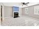 Open-concept living room with tile flooring, fireplace and a ceiling fan at 103 Sir Gregory Nw Mnr, Lawrenceville, GA 30044