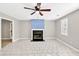 Open-concept living room with tile flooring, fireplace and a ceiling fan at 103 Sir Gregory Nw Mnr, Lawrenceville, GA 30044