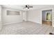 Bright living room with tile flooring, ceiling fan and view into another room at 103 Sir Gregory Nw Mnr, Lawrenceville, GA 30044