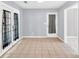 Sunroom with tiled floors and double doors leading to the backyard at 103 Sir Gregory Nw Mnr, Lawrenceville, GA 30044