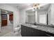 Well-lit bathroom featuring a granite countertop vanity and convenient access to a walk-in closet at 250 Pharr Ne Rd # 716, Atlanta, GA 30305