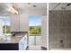 Bright bathroom featuring granite countertops, double vanity, a walk-in shower and a balcony access at 250 Pharr Ne Rd # 716, Atlanta, GA 30305