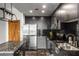 Kitchen with island, stainless steel appliances, granite counters, and dark backsplash at 250 Pharr Ne Rd # 716, Atlanta, GA 30305