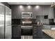 Stylish kitchen with stainless steel appliances, granite counters, and dark backsplash at 250 Pharr Ne Rd # 716, Atlanta, GA 30305