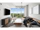 Bright living room featuring modern decor, large windows, and a balcony with city views at 250 Pharr Ne Rd # 716, Atlanta, GA 30305