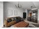 Cozy living room with leather sofa, modern lighting, and access to the kitchen at 250 Pharr Ne Rd # 716, Atlanta, GA 30305