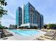 Exterior view of the building and community pool with plenty of lounge chairs at 250 Pharr Ne Rd # 716, Atlanta, GA 30305