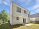 A view of the back exterior of the home including yard, siding, doors, and windows at 7007 Setters Way, Lithonia, GA 30038