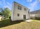 View of backyard featuring a well-maintained lawn and a white siding home with a sliding glass door at 7007 Setters Way, Lithonia, GA 30038