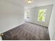 A cozy bedroom with two bright windows, plush carpeting, and fresh neutral paint creating a serene atmosphere at 7007 Setters Way, Lithonia, GA 30038