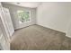 Comfortable carpeted bedroom filled with natural light from the bright window at 7007 Setters Way, Lithonia, GA 30038