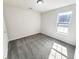 A bright bedroom featuring fresh paint and plush carpet with a sunny window at 7007 Setters Way, Lithonia, GA 30038