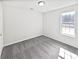 This bedroom has neutral colored walls, new gray carpet, and a large window at 7007 Setters Way, Lithonia, GA 30038