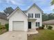 Charming two-story home with attached garage and well-manicured front lawn and blue door at 7007 Setters Way, Lithonia, GA 30038