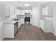 Modern kitchen with sleek stainless steel appliances, plenty of cabinet space, and light countertops at 7007 Setters Way, Lithonia, GA 30038