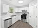 Modern kitchen with stainless steel appliances, ample counter space, and sleek white cabinets at 7007 Setters Way, Lithonia, GA 30038