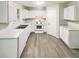 Bright kitchen with white cabinets, countertop, and modern appliances at 7007 Setters Way, Lithonia, GA 30038