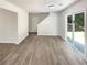 Open-concept living space features durable floors and seamless access to both the outdoors and a staircase at 7007 Setters Way, Lithonia, GA 30038