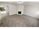 Spacious living room featuring carpet flooring, a fireplace, and neutral walls at 7007 Setters Way, Lithonia, GA 30038
