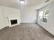 Bright living room with a fireplace, carpet flooring, and plenty of natural light at 7007 Setters Way, Lithonia, GA 30038