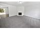 Spacious living room featuring neutral carpet and a white fireplace at 7007 Setters Way, Lithonia, GA 30038