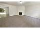 Spacious living room with fireplace, plush carpeting, and adjacent dining area at 7007 Setters Way, Lithonia, GA 30038