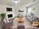Bright living room with a fireplace, comfortable seating, and plenty of natural light at 7007 Setters Way, Lithonia, GA 30038