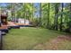 Backyard features lush greenery, a shed, and a terraced landscape at 106 Hickory Ave, Fayetteville, GA 30215