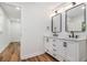Bathroom featuring a double vanity with rectangular mirrors and drawers, and wood-look flooring at 106 Hickory Ave, Fayetteville, GA 30215