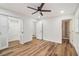 Bright bedroom featuring hardwood floors, ceiling fan, closet, and an ensuite bathroom with tiled shower at 106 Hickory Ave, Fayetteville, GA 30215
