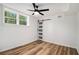 Bedroom featuring hardwood floors, ceiling fan and a barn door closet, and a window at 106 Hickory Ave, Fayetteville, GA 30215