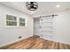 Comfortable bedroom with hardwood floors, barn door closet, and a view from a double window at 106 Hickory Ave, Fayetteville, GA 30215