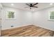 White bedroom featuring hardwood floors, and views from windows at 106 Hickory Ave, Fayetteville, GA 30215