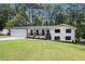 Charming renovated home with a freshly painted white brick exterior, black trim, and an inviting front porch at 106 Hickory Ave, Fayetteville, GA 30215