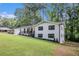 Charming renovated home with a freshly painted white brick exterior, black trim, and an inviting front porch at 106 Hickory Ave, Fayetteville, GA 30215