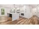 Modern kitchen with white cabinets, stainless steel appliances, marble backsplash and countertop island at 106 Hickory Ave, Fayetteville, GA 30215