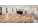 Bright open-concept living area features hardwood floors, white walls, and a stylish black kitchen island at 106 Hickory Ave, Fayetteville, GA 30215