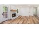 Living room with fireplace, hardwood floors and light filled windows perfect for relaxation and enjoyment at 106 Hickory Ave, Fayetteville, GA 30215