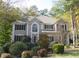 Traditional two-story home with manicured landscaping and mature trees in the front yard at 3643 Fowler Rdg, Douglasville, GA 30135
