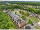 Scenic aerial view of a residential neighborhood with lush green trees and well-maintained homes at 4415 Saint Andrews Crest Dr, Cumming, GA 30040