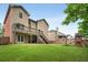 Large backyard with a deck, lush grass, and a play set at 4415 Saint Andrews Crest Dr, Cumming, GA 30040