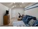 Finished basement featuring a blue couch, exercise equipment and tile flooring at 4415 Saint Andrews Crest Dr, Cumming, GA 30040
